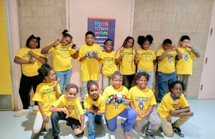  Carleton Robotics Students with smiles taking a quick photo after attending Robotics event.